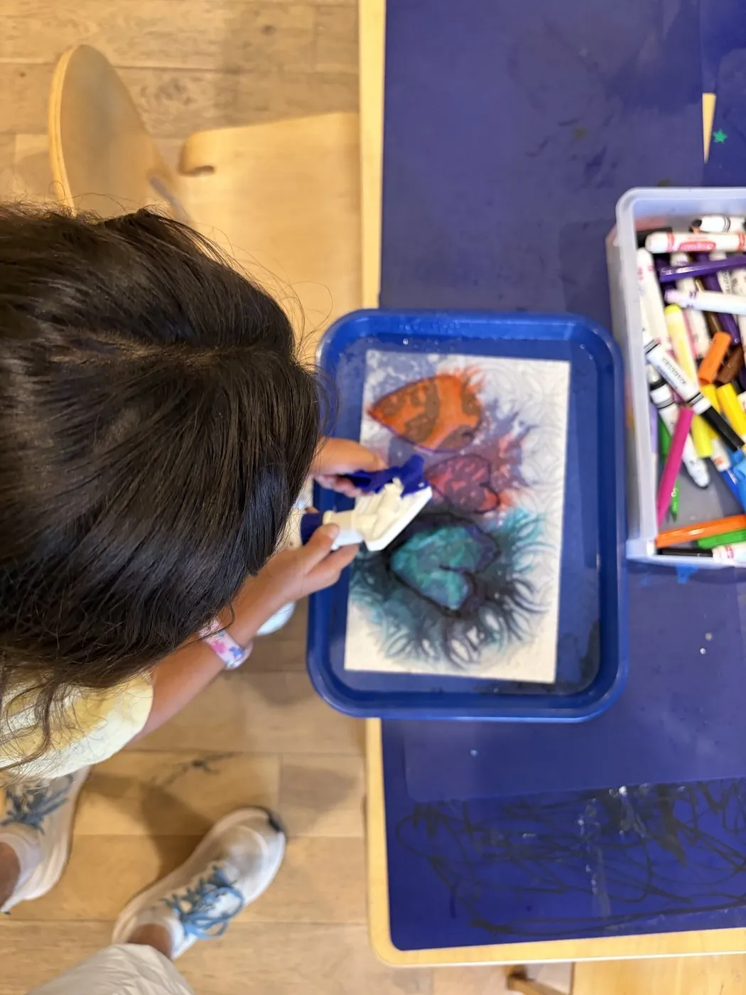 Children creating art at the easel