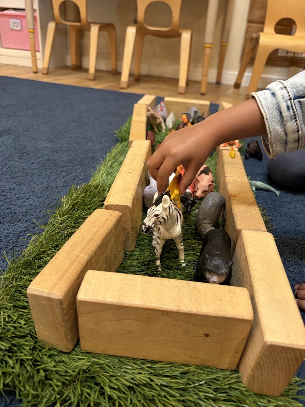 Bright preschool classroom with child-sized furniture and learning centers